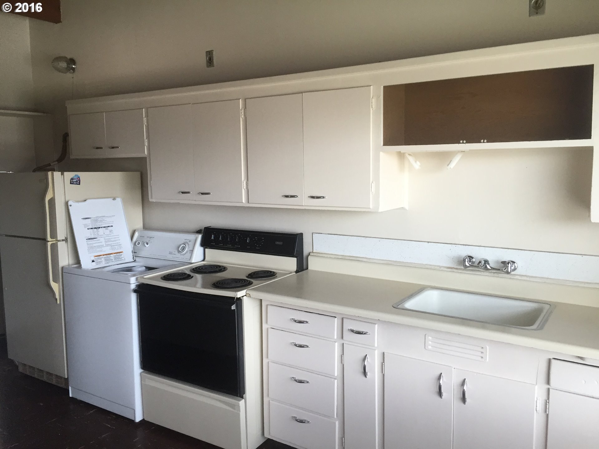 1609 Nevada Street The Dalles, OR 97058 - Photo 22 of 24 a kitchen with stainless steel appliances granite countertop a sink and a stove