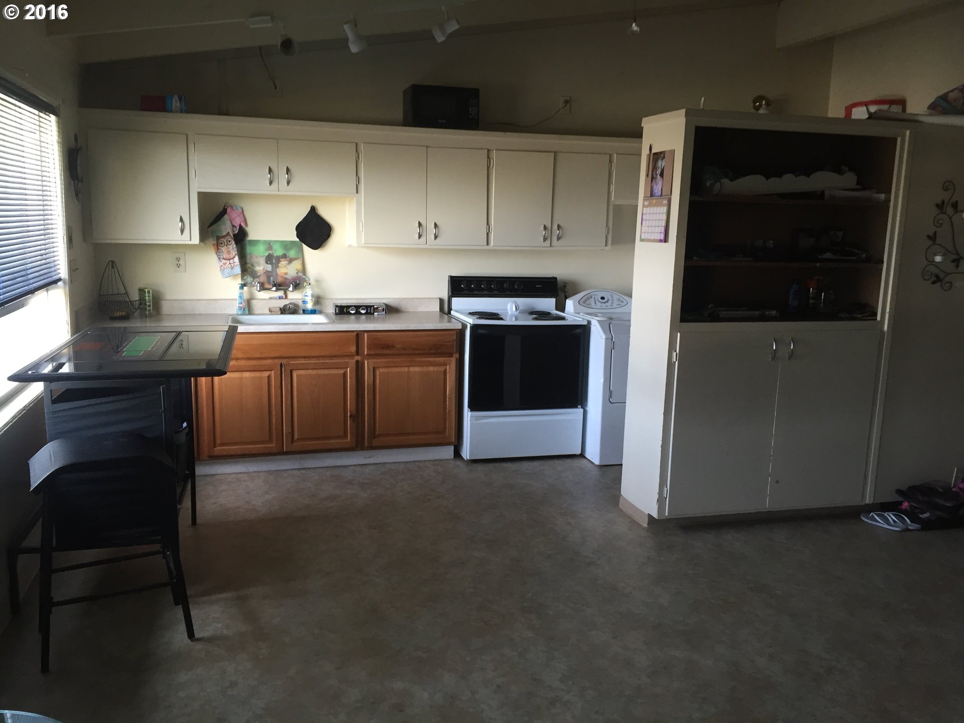 1609 Nevada Street The Dalles, OR 97058 - Photo 8 of 24 a kitchen with granite countertop a refrigerator stove and sink