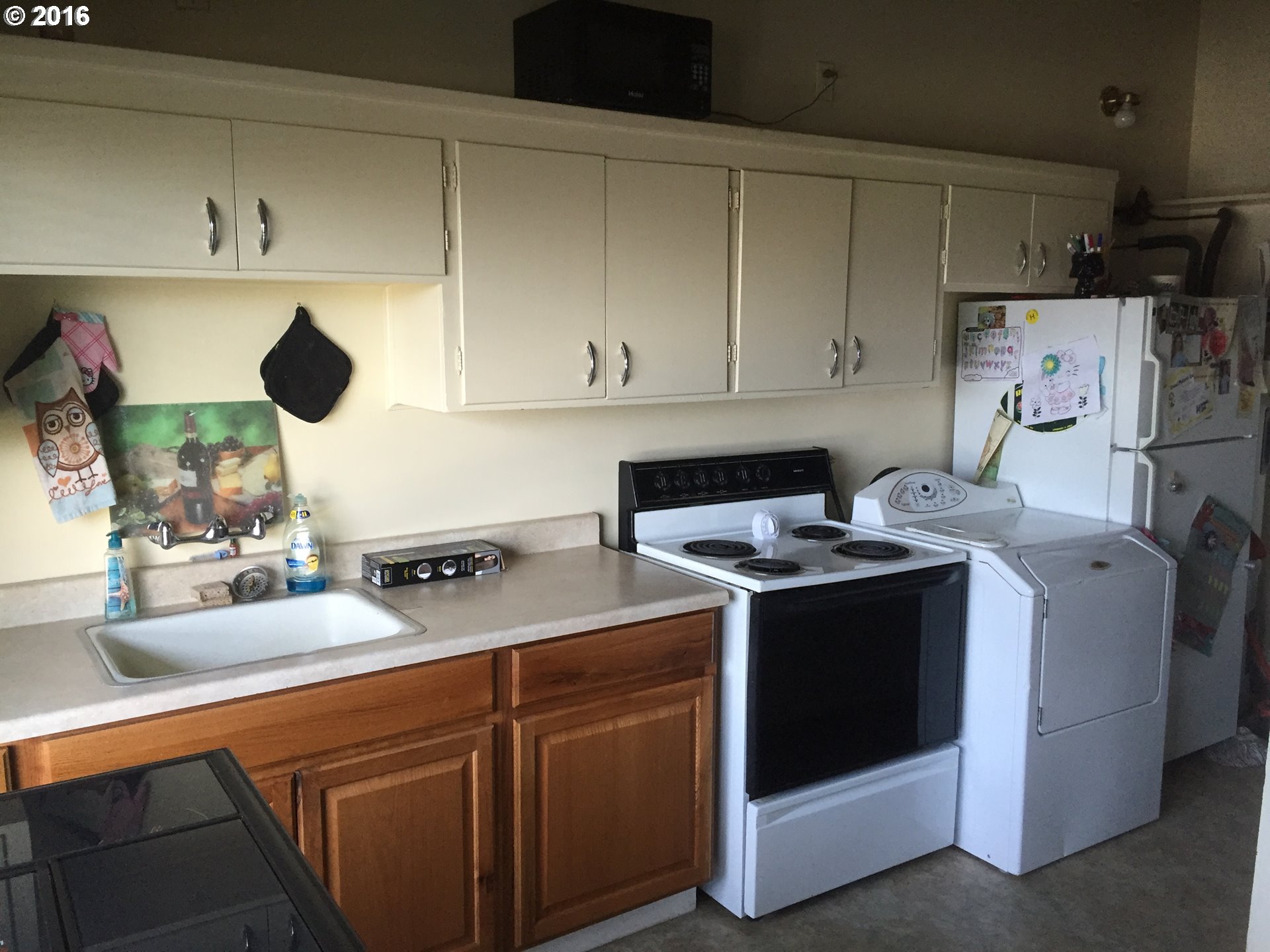 1609 Nevada Street The Dalles, OR 97058 - Photo 9 of 24 a kitchen with stainless steel appliances granite countertop a sink stove and refrigerator