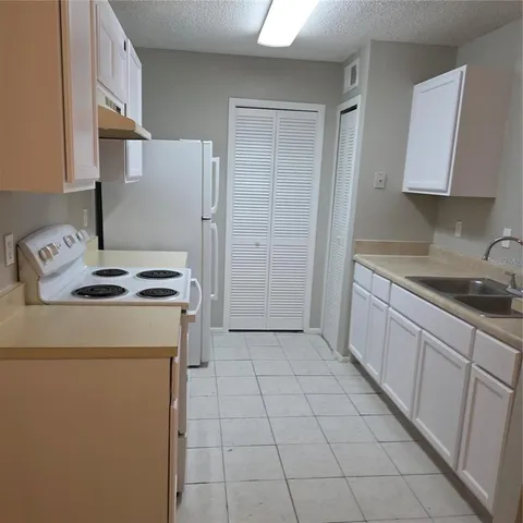 a kitchen with a cabinets and a stove top oven