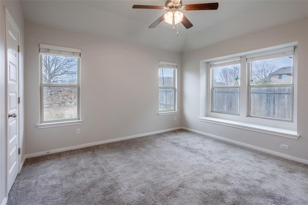 615 Stampede Road San Marcos, TX 78666 - Photo 12 of 26 A quiet bedroom retreat with plush carpet and a sun-filled window seat perfect for reading.