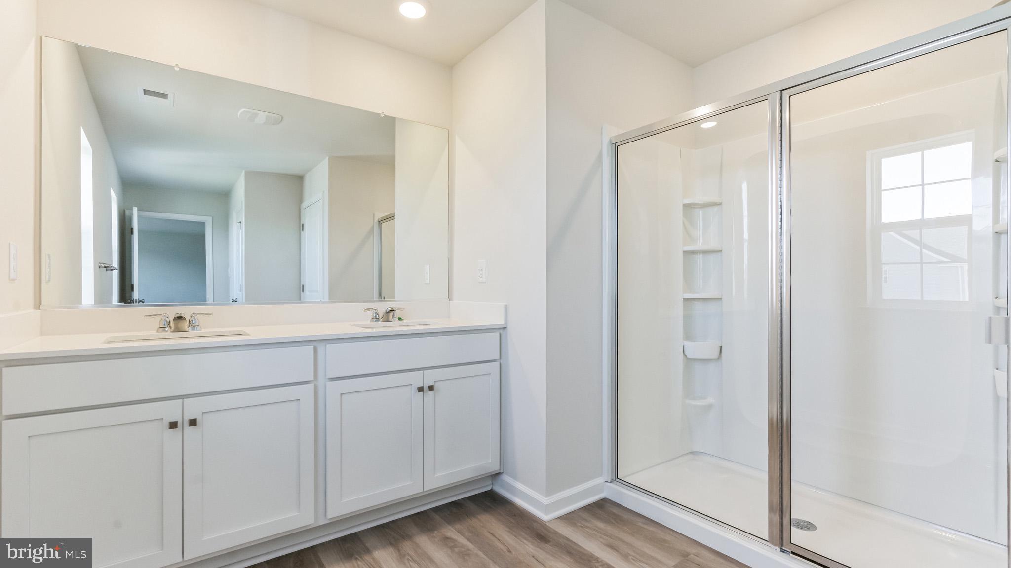 423 Kingston Drive Cherry Hill, NJ 08034 - Photo 20 of 27 a bathroom with double vanity sinks and a mirror