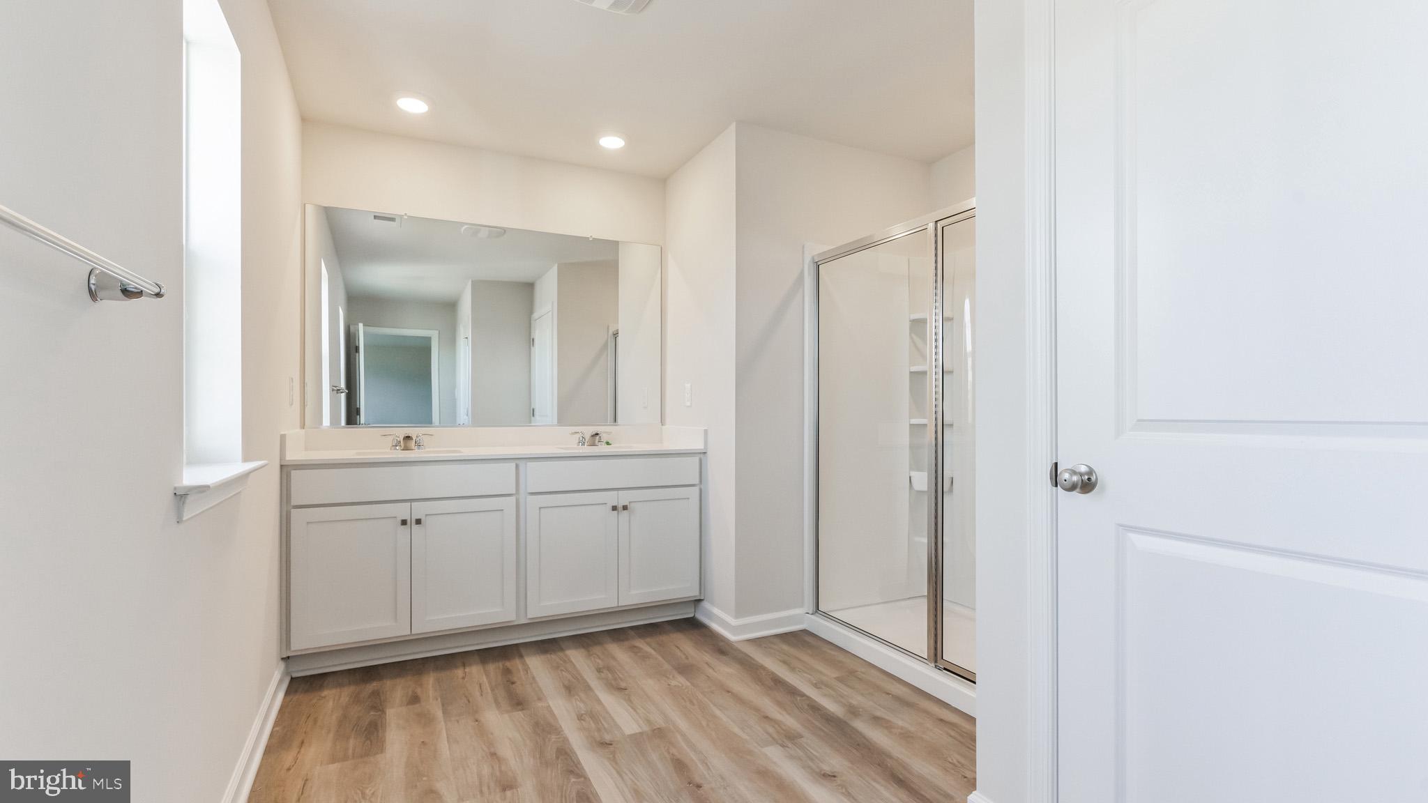 423 Kingston Drive Cherry Hill, NJ 08034 - Photo 21 of 27 a spacious bathroom with a mirror and a shower