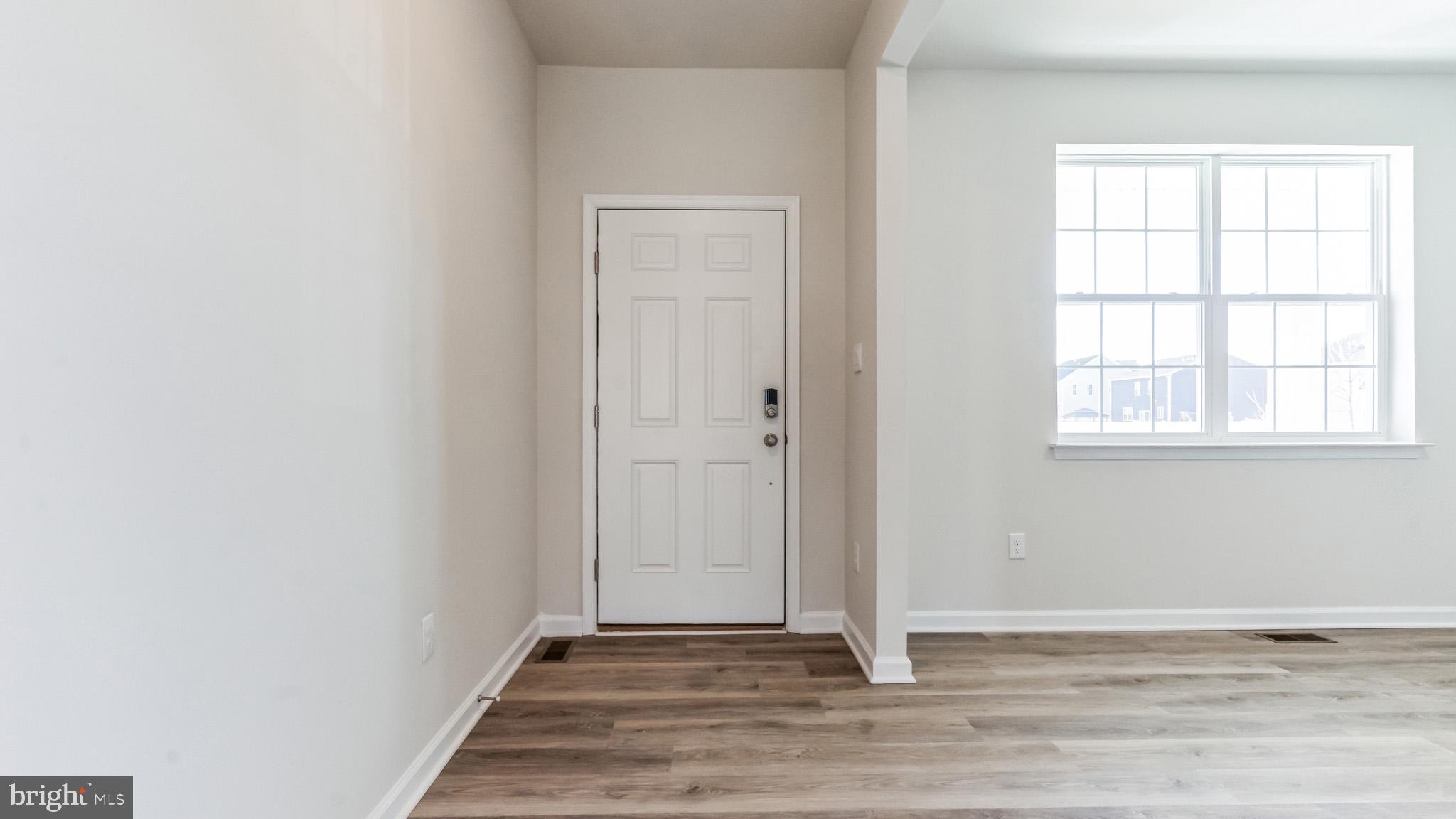 423 Kingston Drive Cherry Hill, NJ 08034 - Photo 3 of 27 a view of an empty room with wooden floor and a window