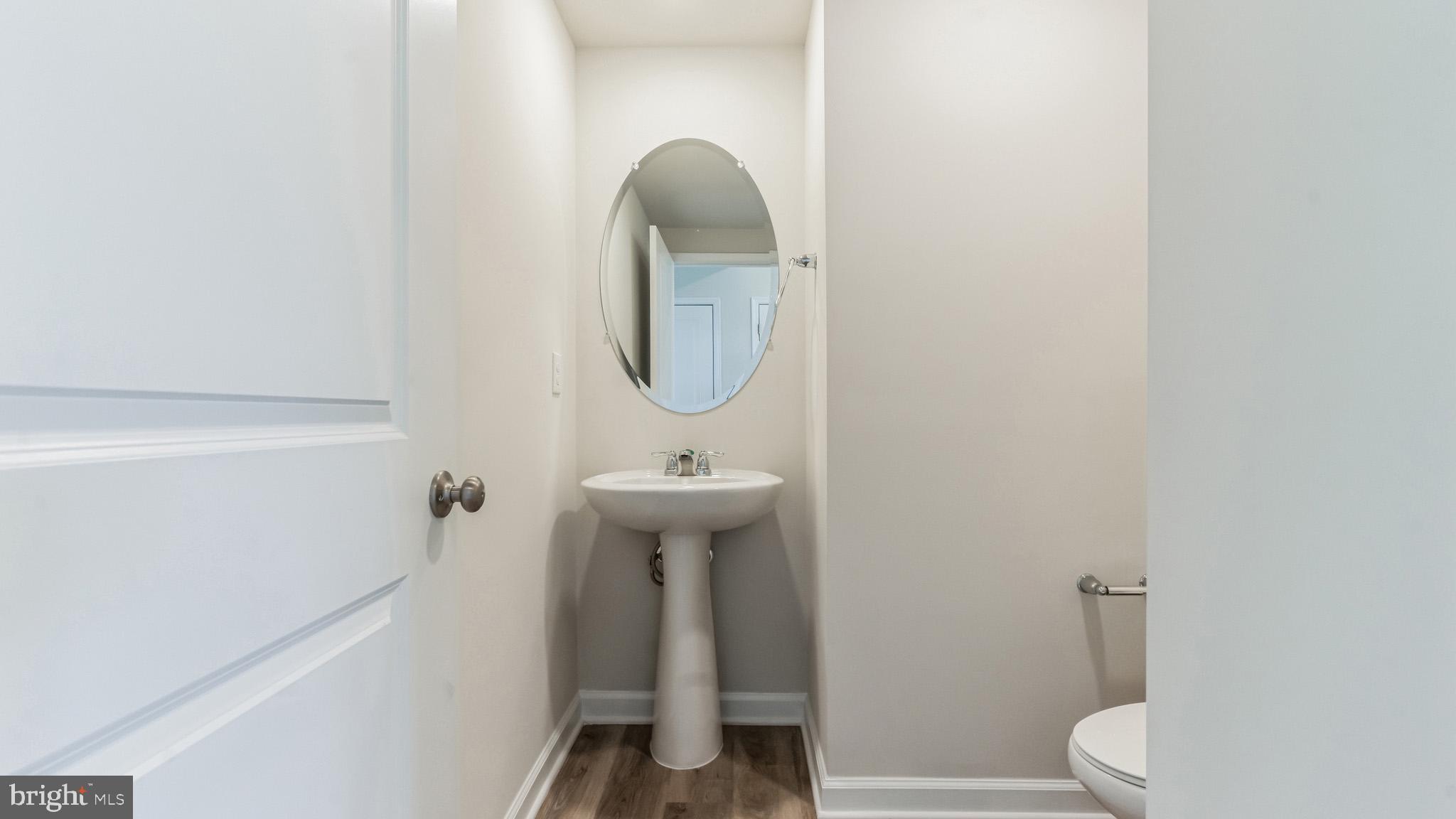 423 Kingston Drive Cherry Hill, NJ 08034 - Photo 6 of 27 a bathroom with a sink toilet and a mirror