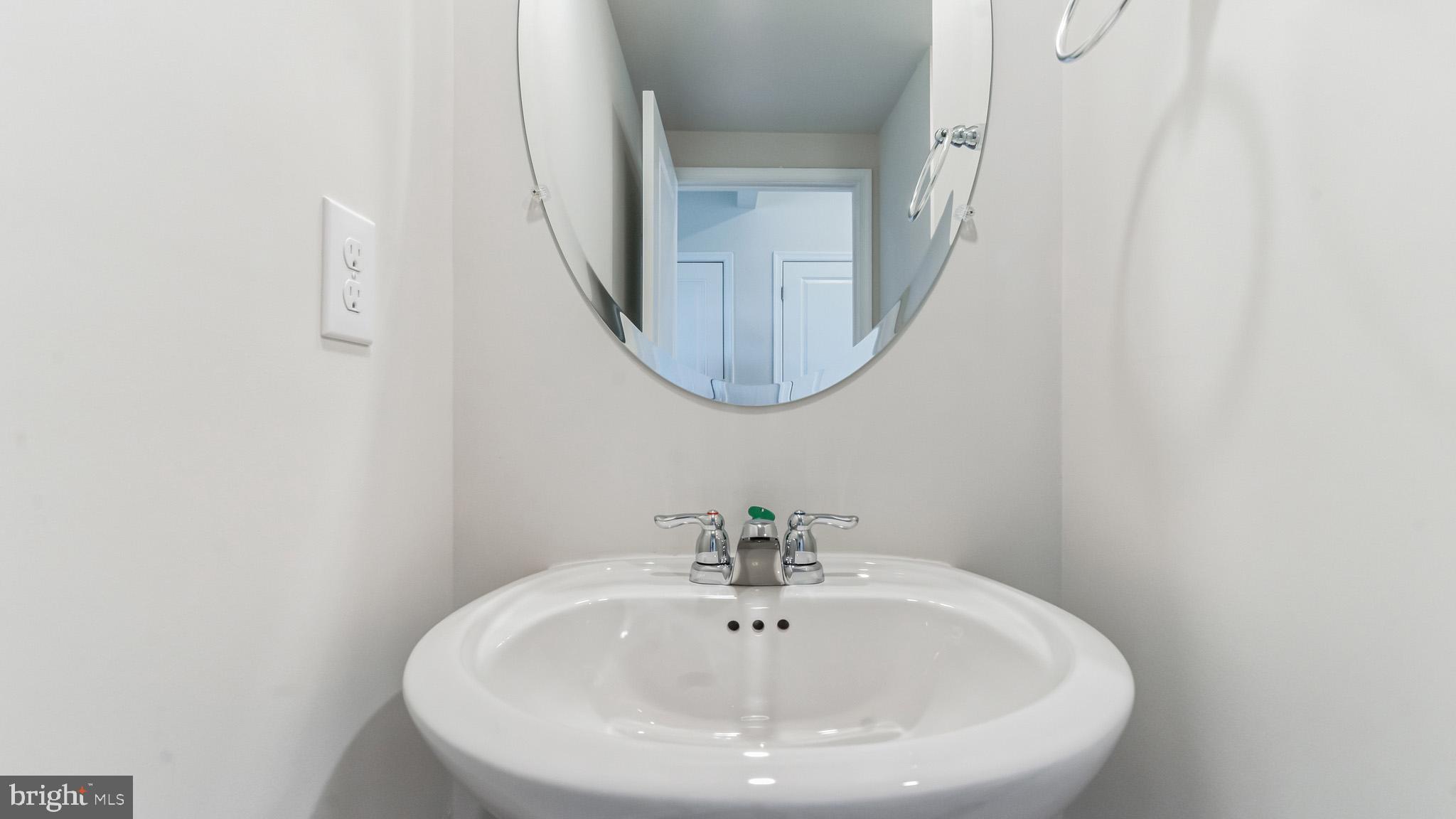 423 Kingston Drive Cherry Hill, NJ 08034 - Photo 7 of 27 a bathroom with a sink and a mirror