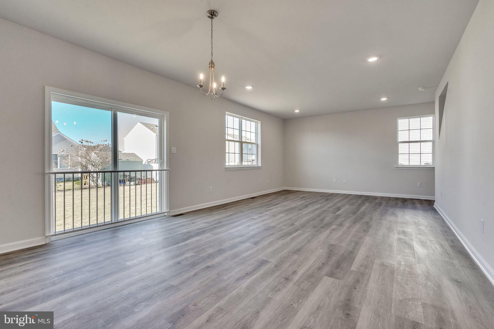 423 Kingston Drive Cherry Hill, NJ 08034 - Photo 8 of 27 a view of an empty room with wooden floor and a window