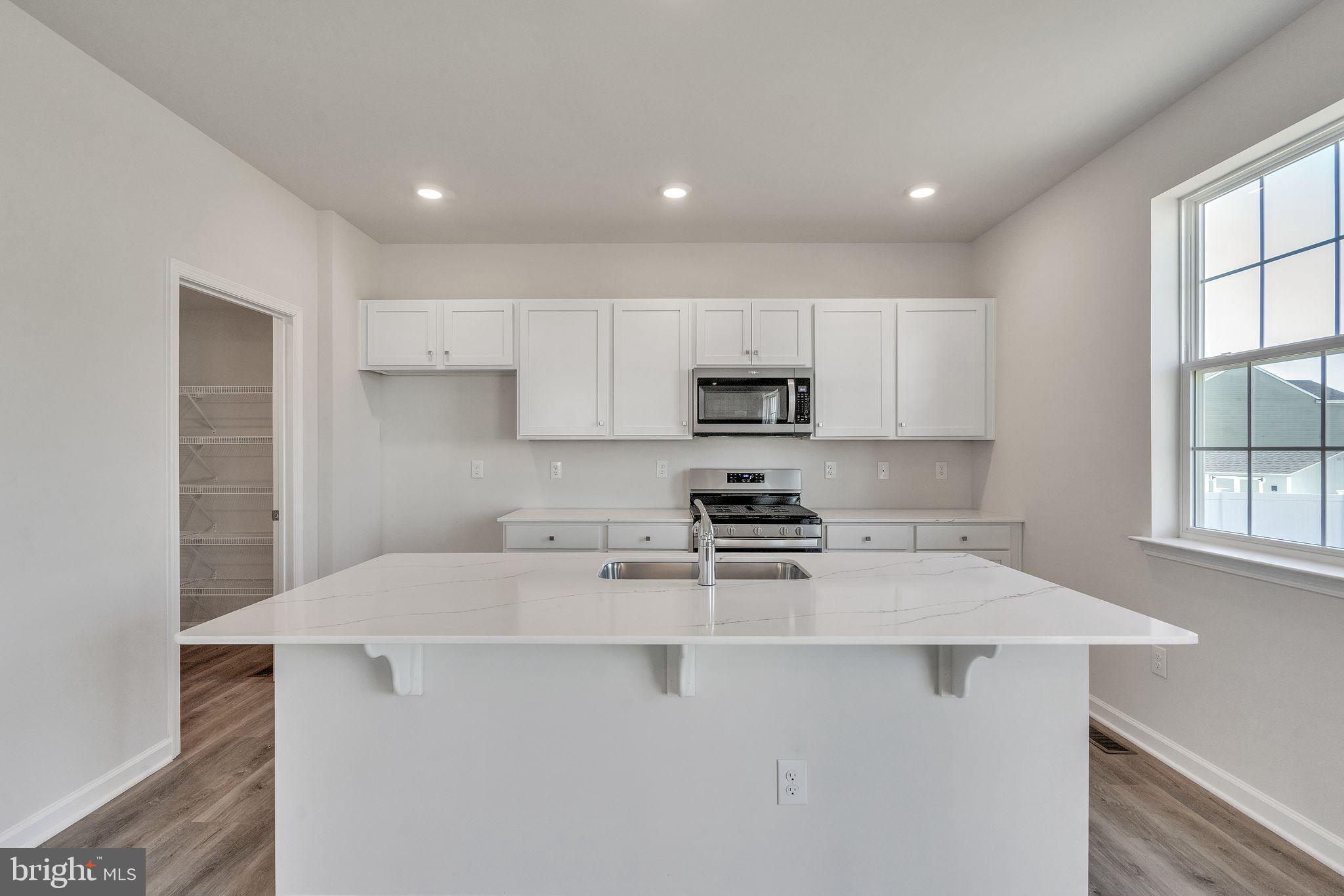423 Kingston Drive Cherry Hill, NJ 08034 - Photo 10 of 27 a kitchen with stainless steel appliances a stove top oven a sink a refrigerator a window and white cabinets