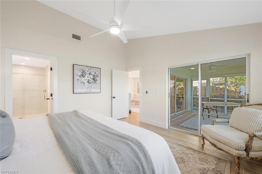 2604 Sailors Way, Unit 120 Naples, FL 34109 - Photo 18 of 27 a bedroom with a bed and a large window