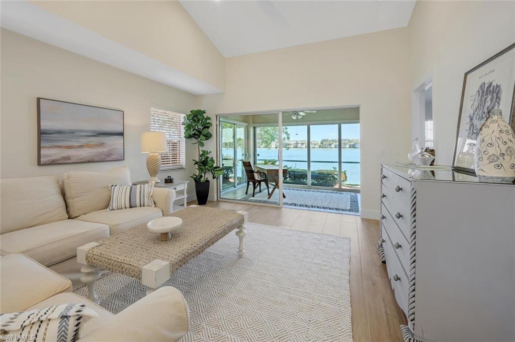 2604 Sailors Way, Unit 120 Naples, FL 34109 - Photo 6 of 27 a living room with furniture and a large window