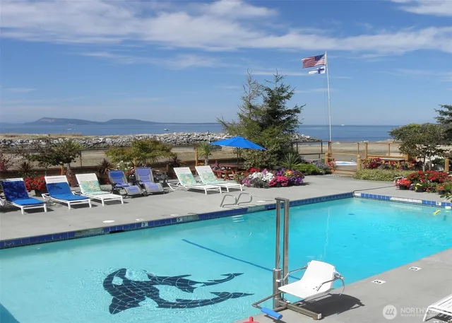 a view of a swimming pool with a table and chairs