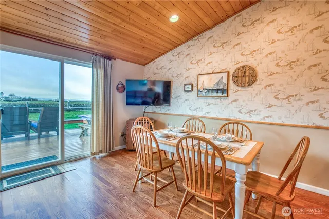 a dining room with furniture and wooden floor