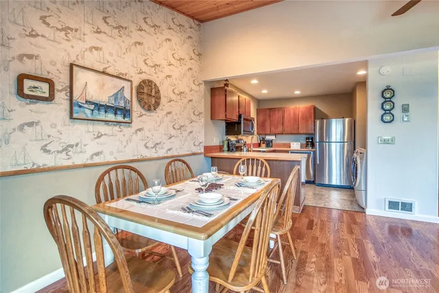 a dining room with furniture and wooden floor