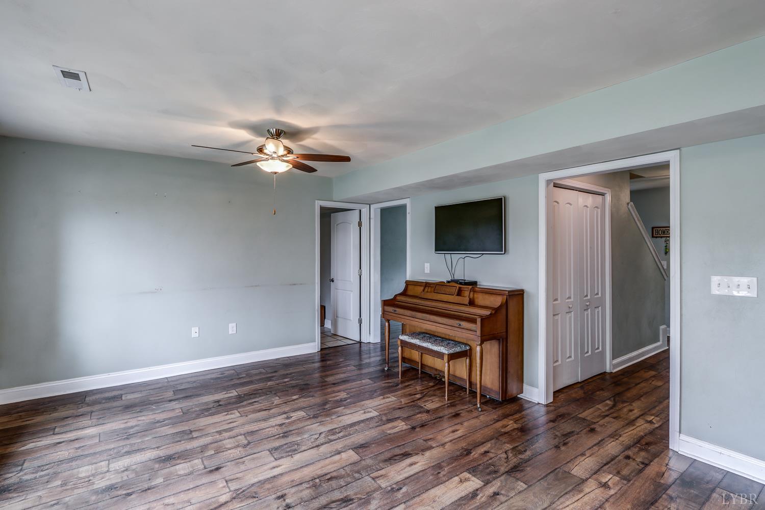 1057 Old Trail Road Forest, VA 24551 - Photo 18 of 49 a living room with furniture and a ceiling fan