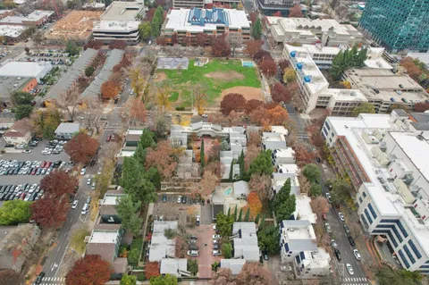 an aerial view of residential houses with outdoor space