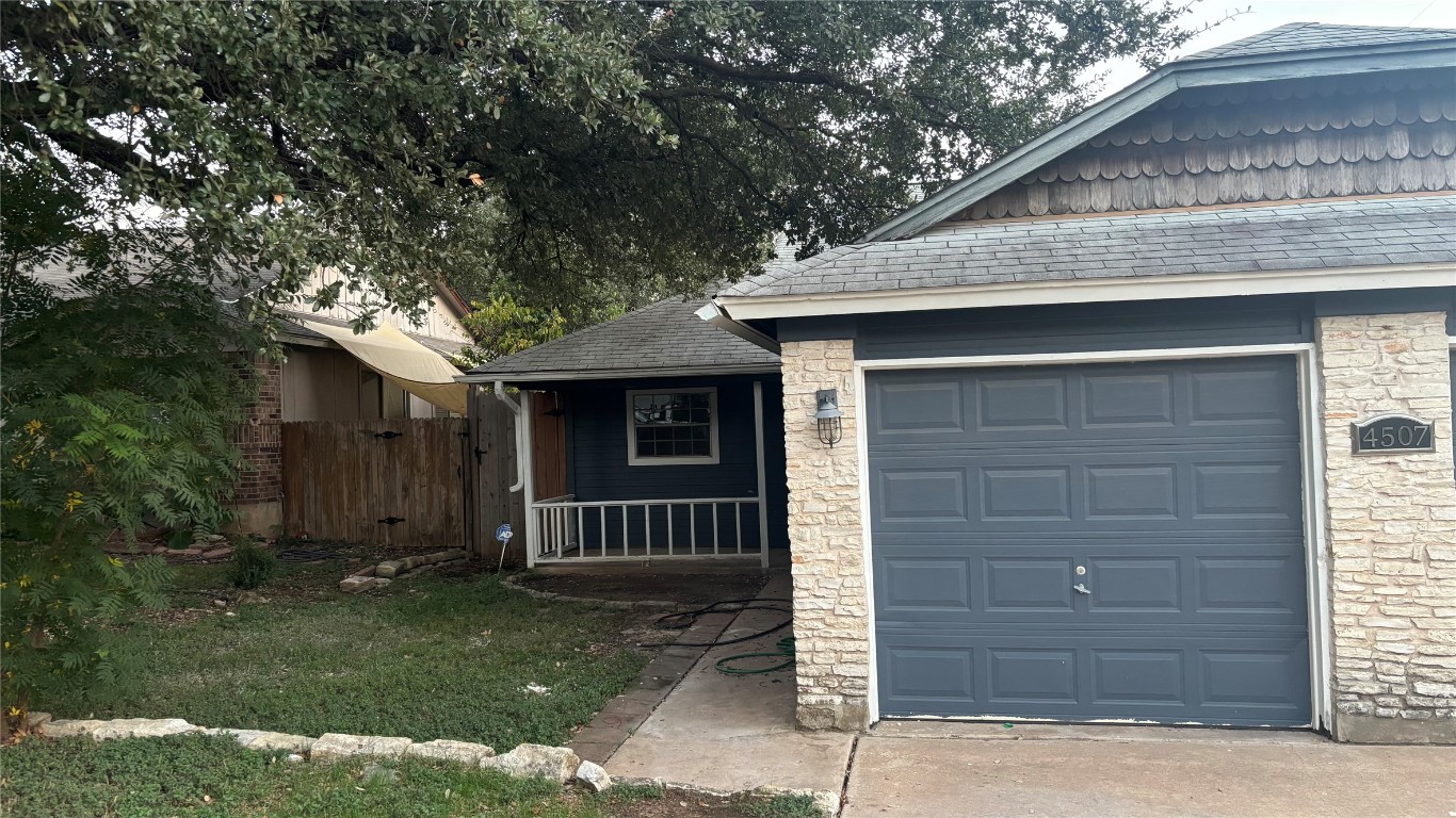4507 Dorsett Oaks Circle, Unit A Austin, TX 78727 - Photo 1 of 26 View of front facade with stone siding and a shingled roof
