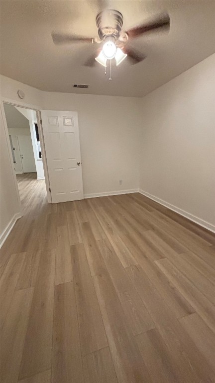 4507 Dorsett Oaks Circle, Unit A Austin, TX 78727 - Photo 13 of 26 Unfurnished room with light wood-style floors and a ceiling fan