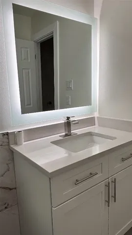 a bathroom with a sink and a mirror