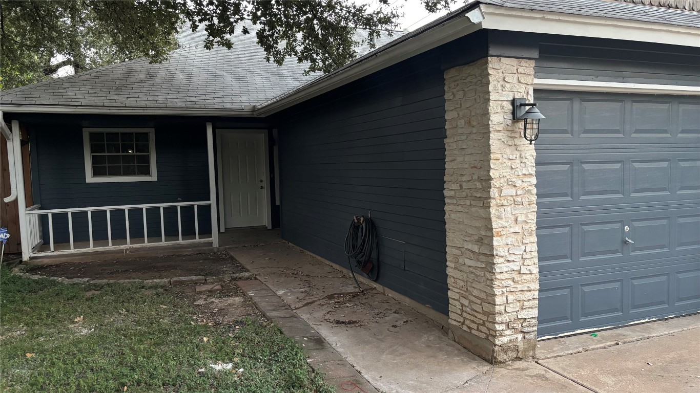 4507 Dorsett Oaks Circle, Unit A Austin, TX 78727 - Photo 2 of 26 Doorway to property with stone siding and roof with shingles