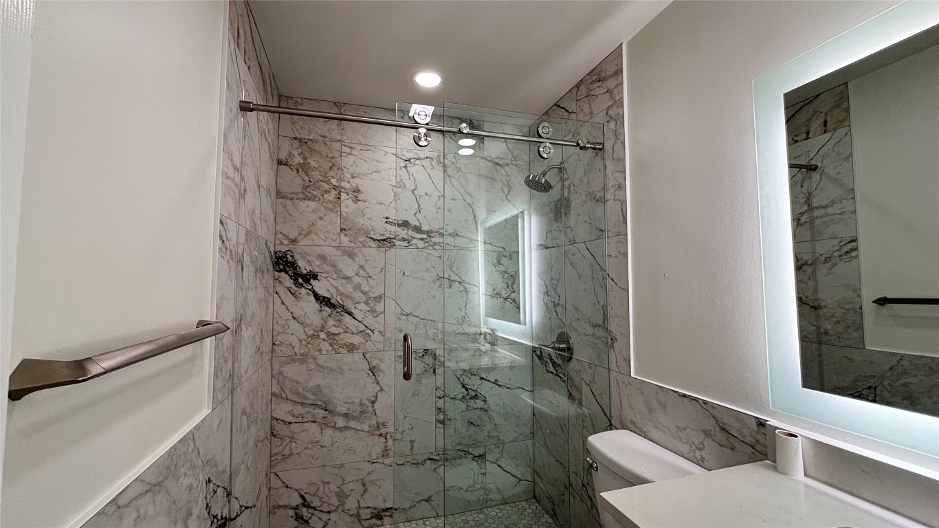 4507 Dorsett Oaks Circle, Unit A Austin, TX 78727 - Photo 21 of 26 Bathroom with vanity and a marble finish shower