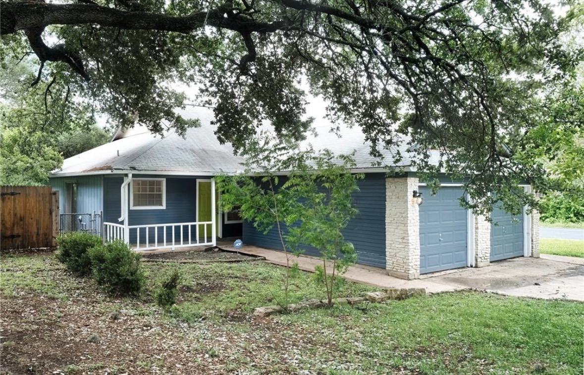 4507 Dorsett Oaks Circle, Unit A Austin, TX 78727 - Photo 26 of 26 View of front facade featuring a garage and a shingled roof