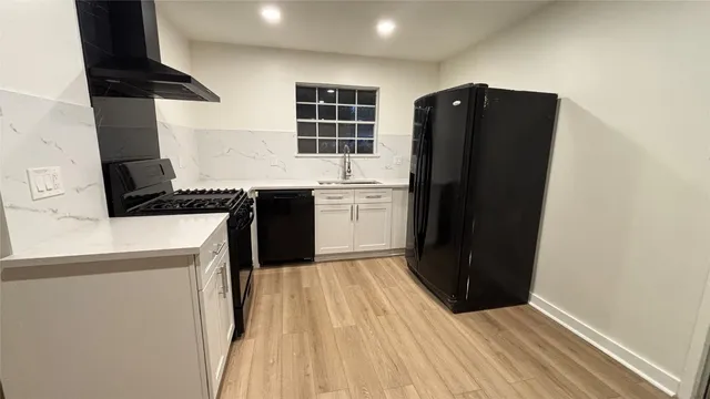 a kitchen with a refrigerator and a stove top oven