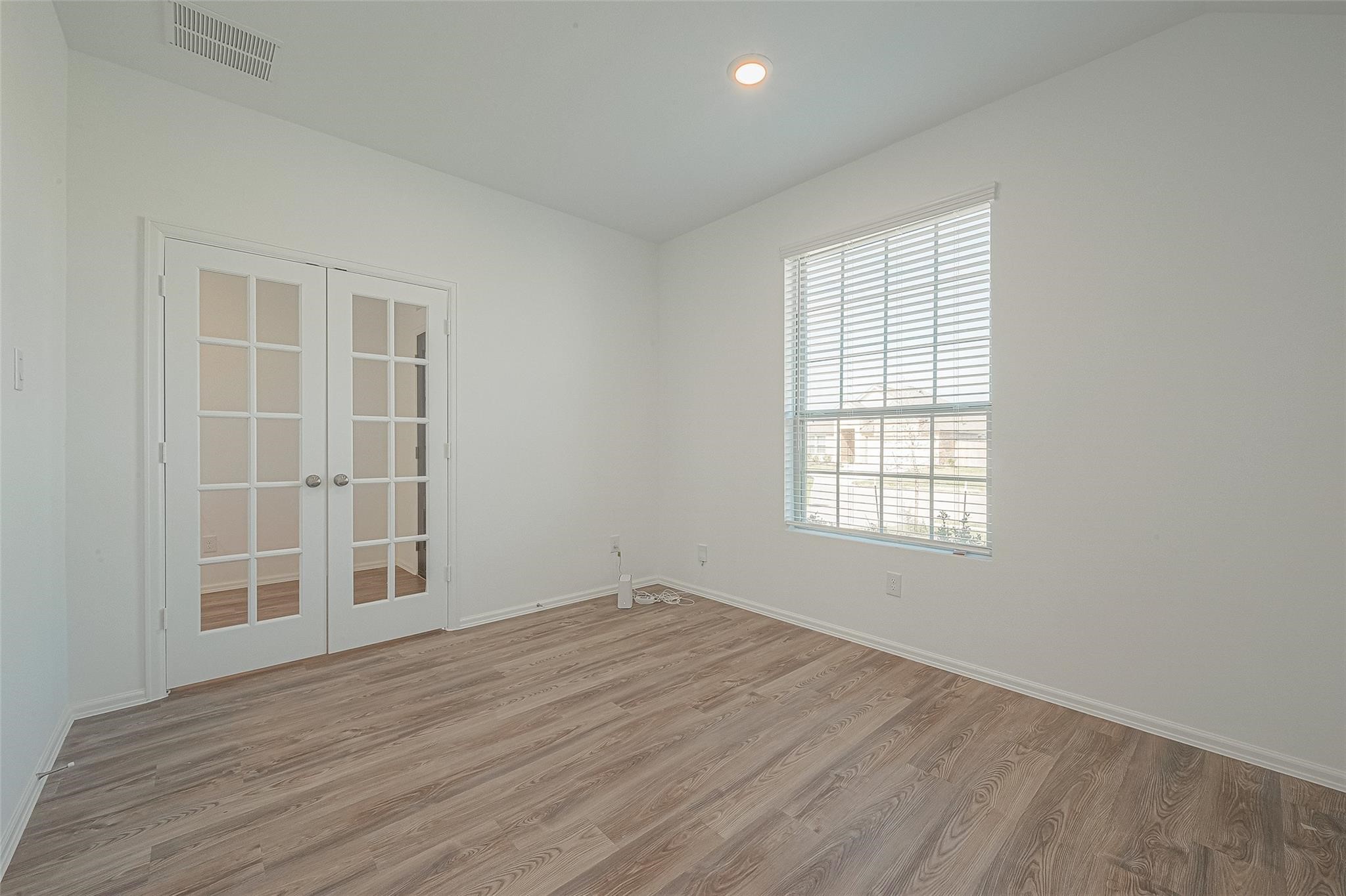 5528 Knox Landing Drive Rosenberg, TX 77469 - Photo 11 of 20 an empty room with wooden floor and windows