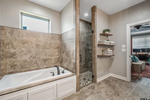 a view of walk in closet with clothes