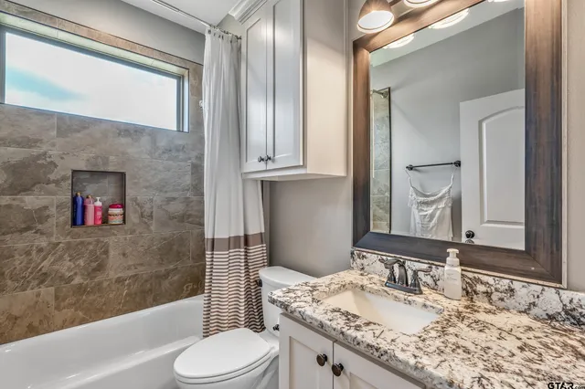 a bedroom with furniture and a wooden floor