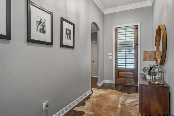 a living room with fireplace furniture and a wooden floor