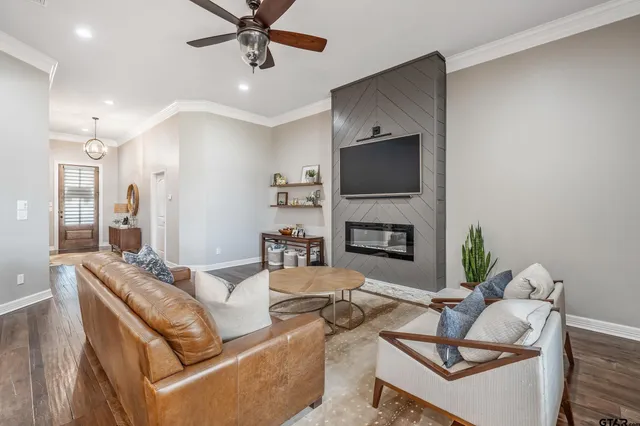 a living room with furniture kitchen and a chandelier