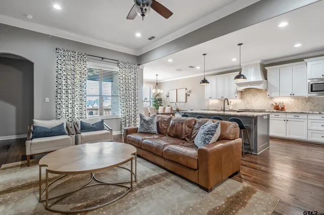 a kitchen with granite countertop wooden floor cabinets and stainless steel appliances