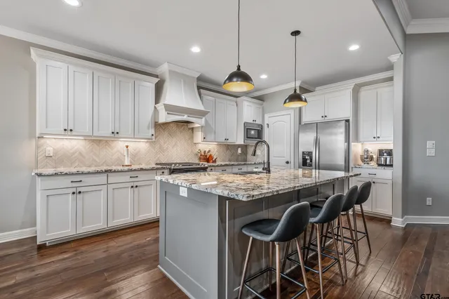 a kitchen with granite countertop a stove and a sink