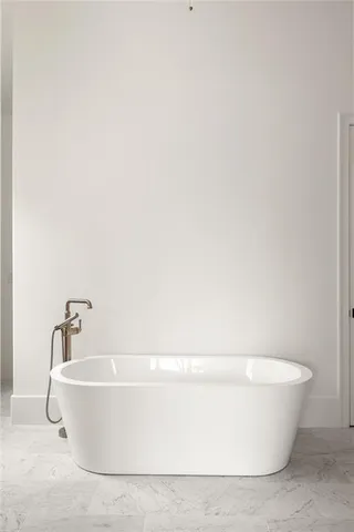 a white tub sitting next to a white sink