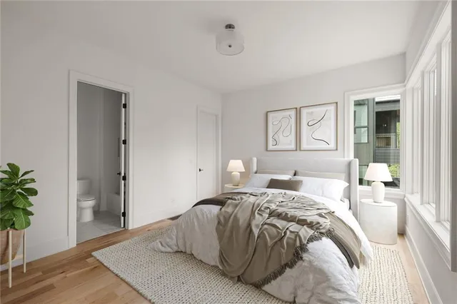 a bedroom with a bed and a potted plant