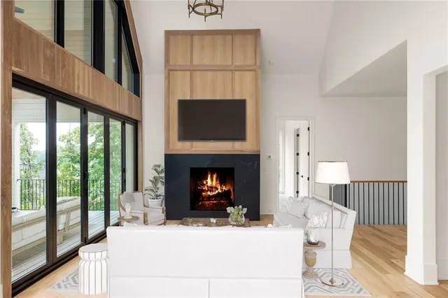 a living room with furniture a fireplace and a flat screen tv