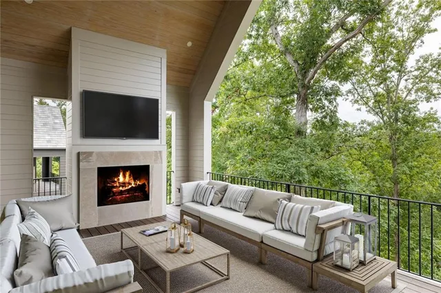a outdoor space with patio fireplace couches and a fireplace