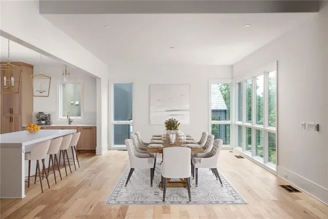 a dining room with furniture window and wooden floor