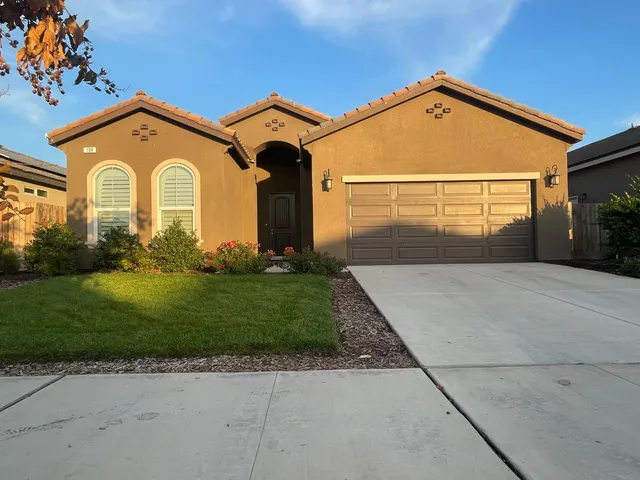 a front view of a house with garden