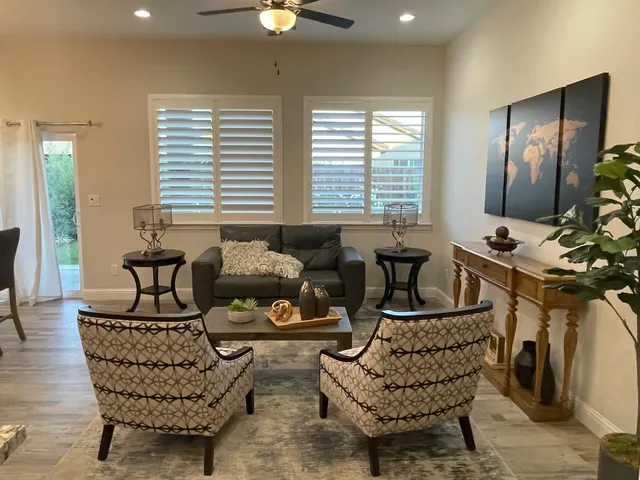 a living room with furniture and wooden floor