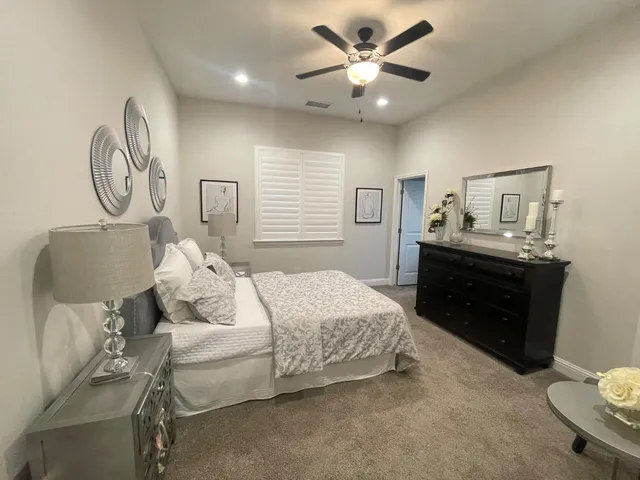 a bedroom with a bed and a chandelier
