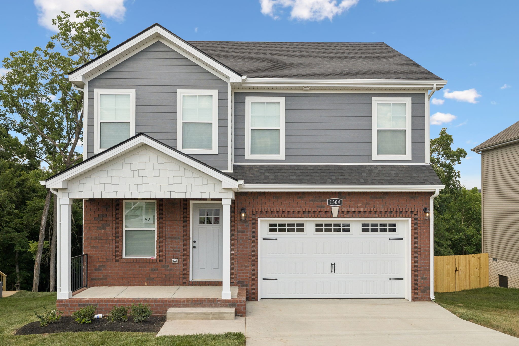 1304 Racker Drive Clarksville, TN 37043 - Photo 2 of 35 a front view of a house with a yard and garage