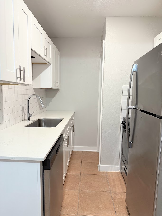 307 East 31st Street, Unit 106 Austin, TX 78705 - Photo 3 of 12 a kitchen with a sink a refrigerator and a sink