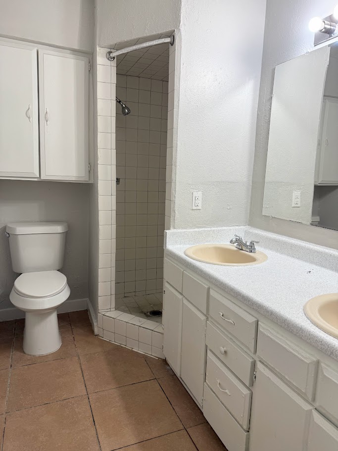 307 East 31st Street, Unit 106 Austin, TX 78705 - Photo 6 of 12 a bathroom with a toilet sink and mirror