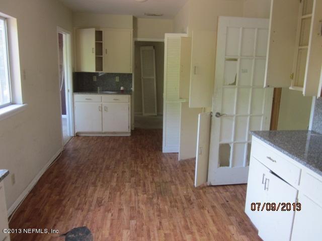 2452 Bayview Road Jacksonville, FL 32210 - Photo 7 of 14 a kitchen with a refrigerator and a stove top oven