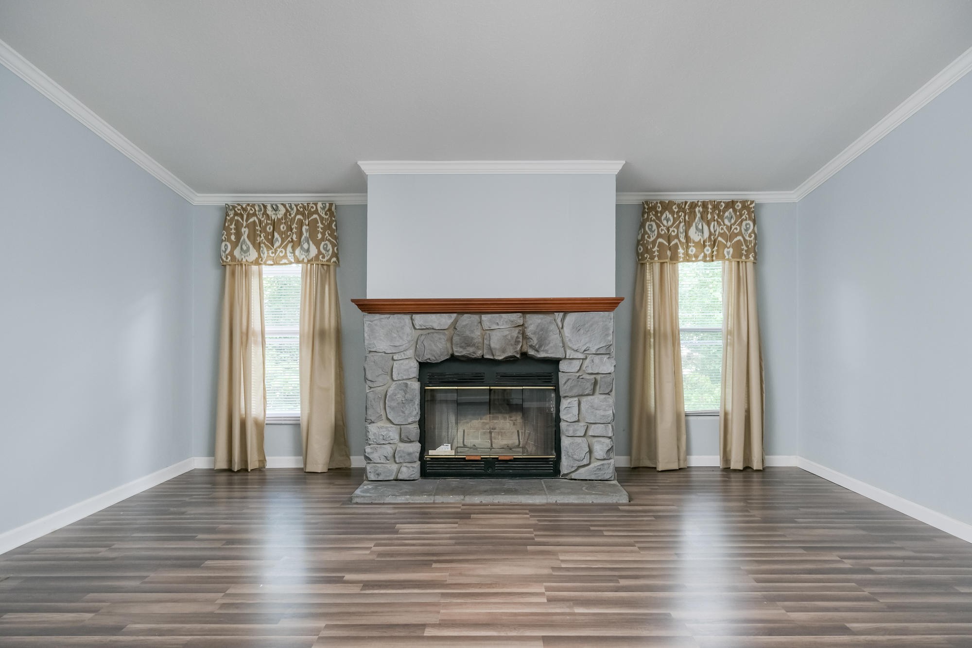 2666 Glass Mill Road Chickamauga, GA 30707 - Photo 7 of 28 a view of an empty room with wooden floor fireplace and a window