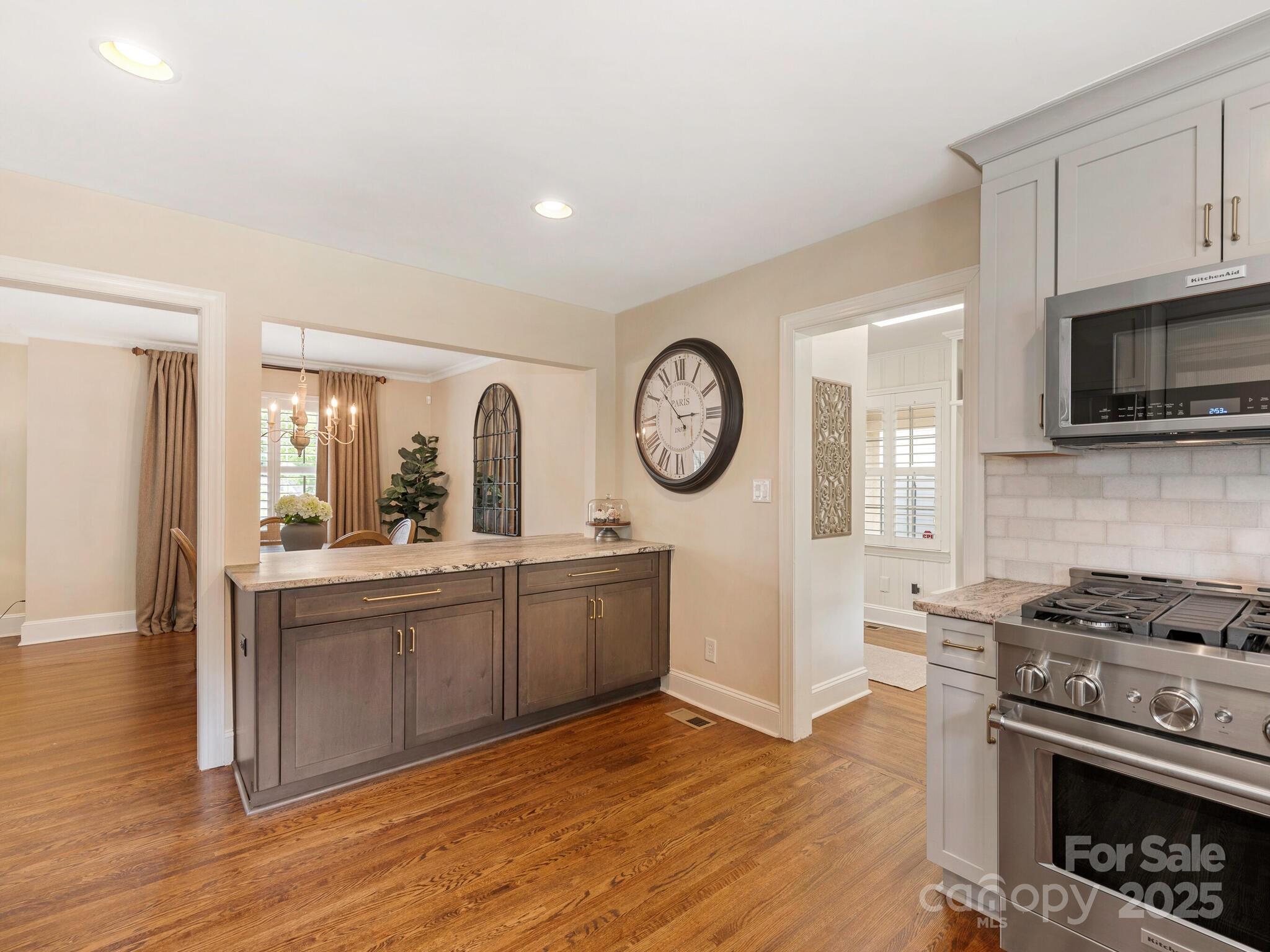 4346 Walker Road Charlotte, NC 28211 - Photo 12 of 30 a kitchen with stainless steel appliances granite countertop a stove a sink and a refrigerator