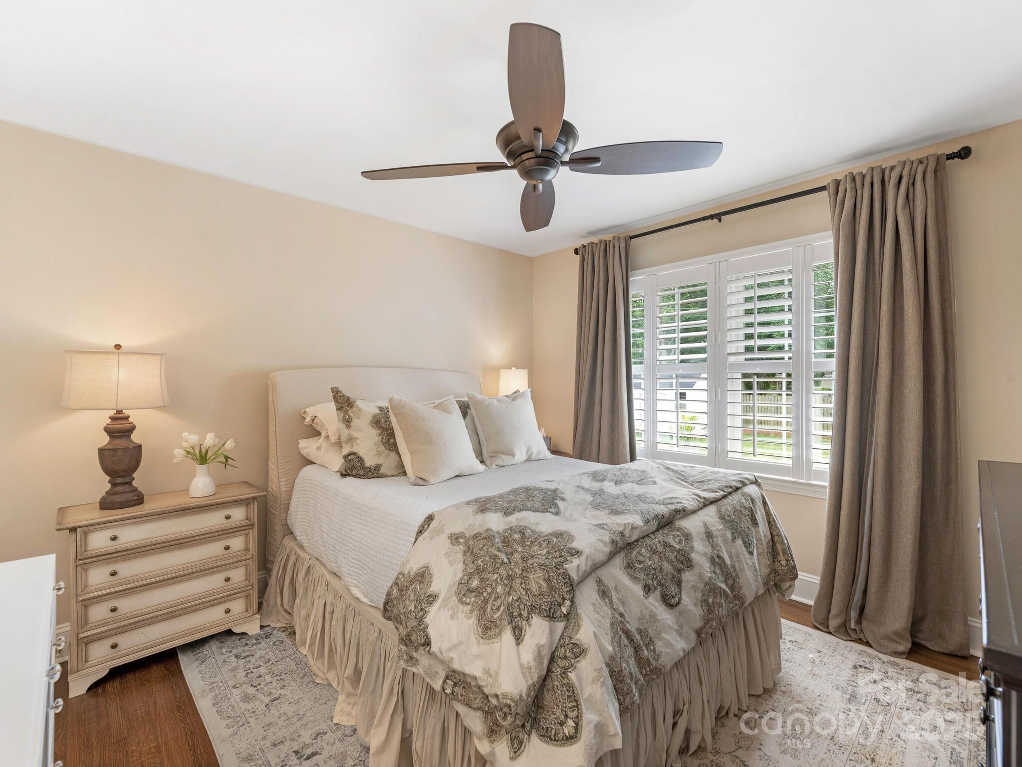 4346 Walker Road Charlotte, NC 28211 - Photo 16 of 30 a bedroom with a bed and wooden floor