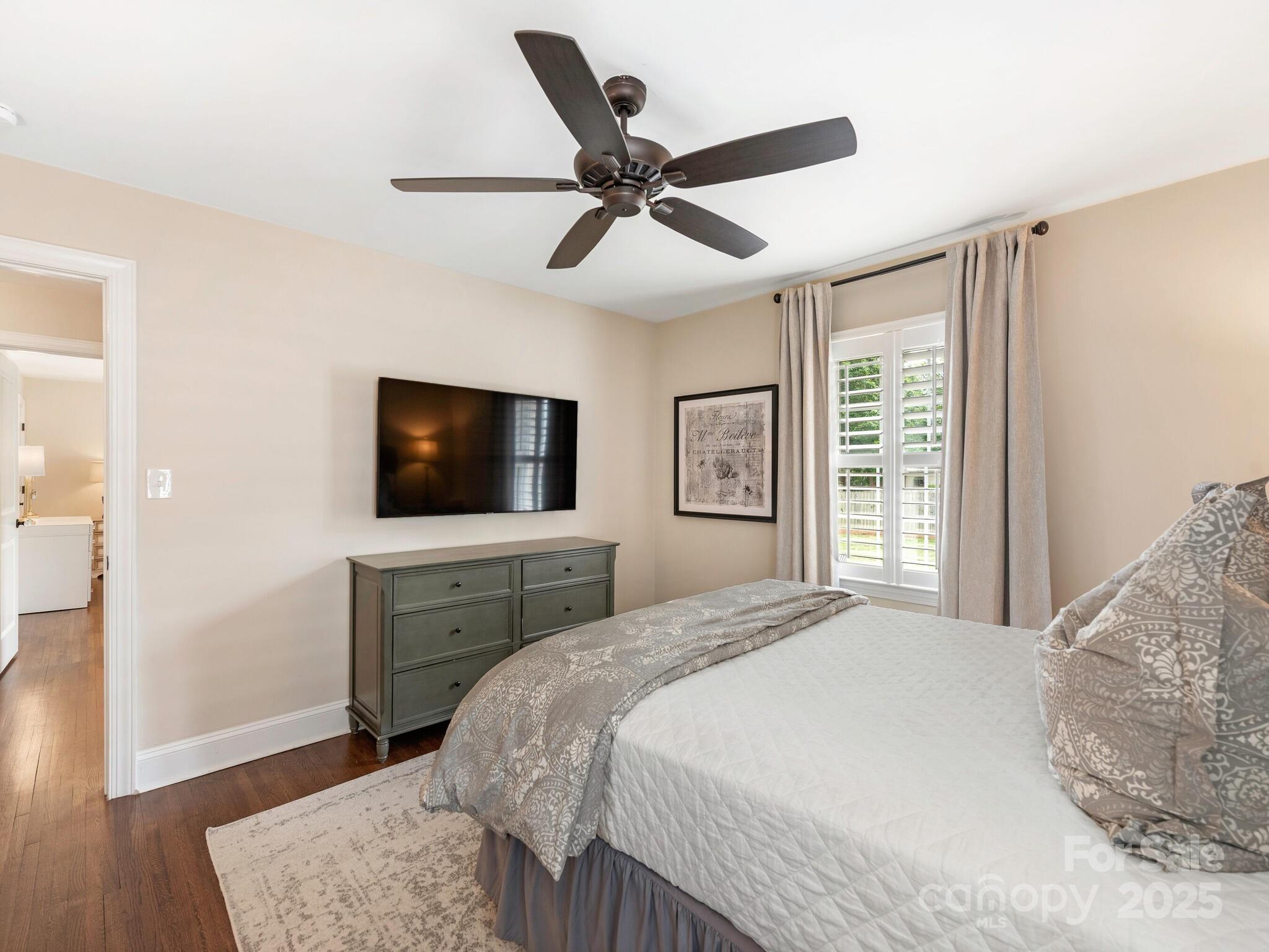 4346 Walker Road Charlotte, NC 28211 - Photo 20 of 30 a bedroom with a bed and a flat screen tv