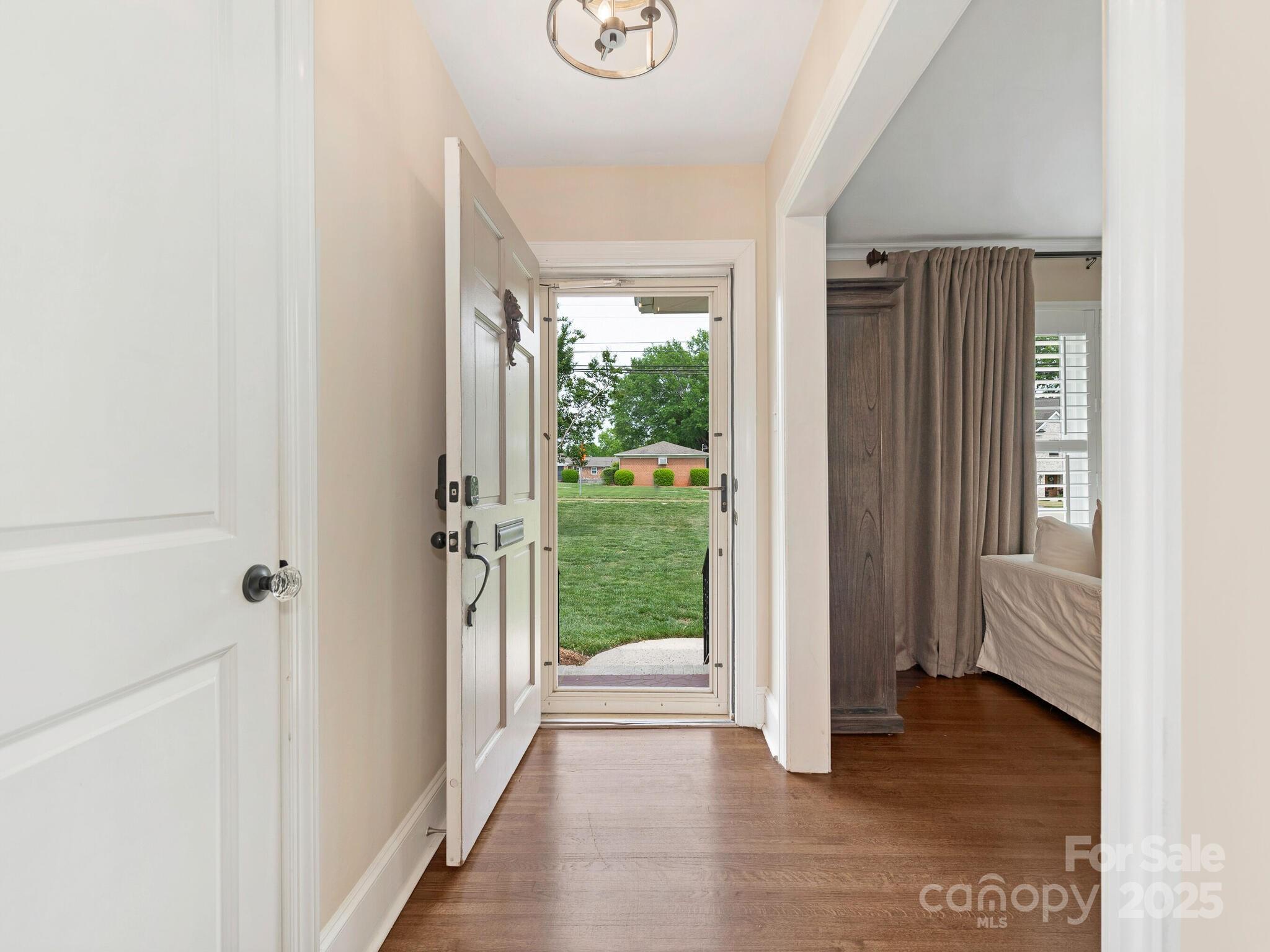 4346 Walker Road Charlotte, NC 28211 - Photo 3 of 30 a view of a hallway with wooden floor and windows